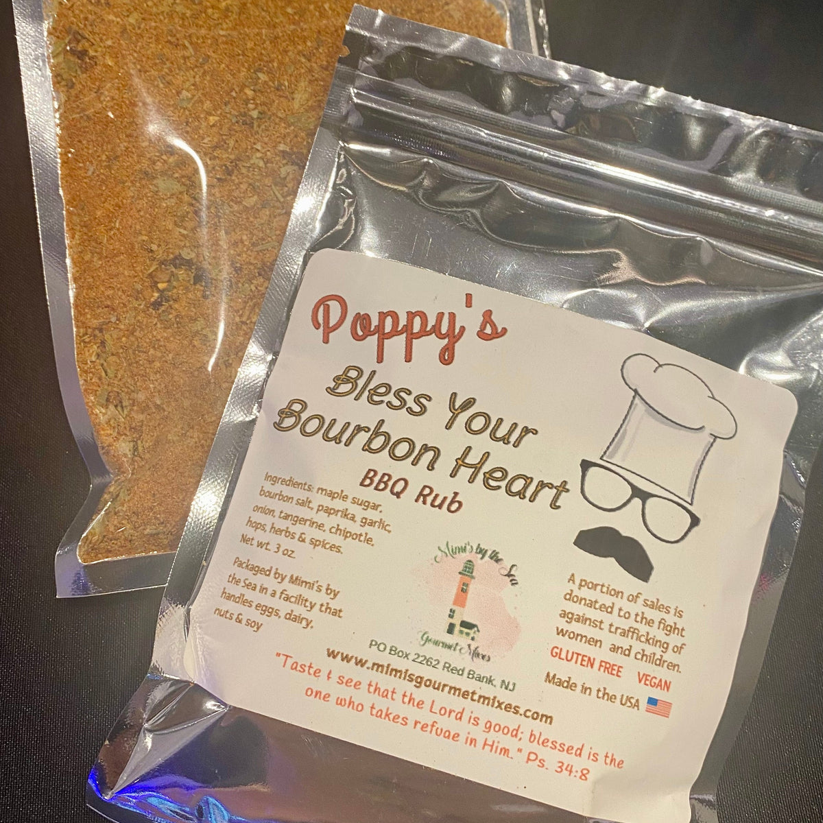 Poppy's Bless Your Bourbon Heart BBQ Rub packaging on a dark surface